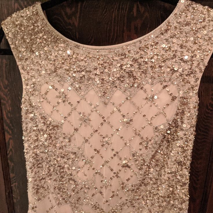 a white dress with silver sequins on it