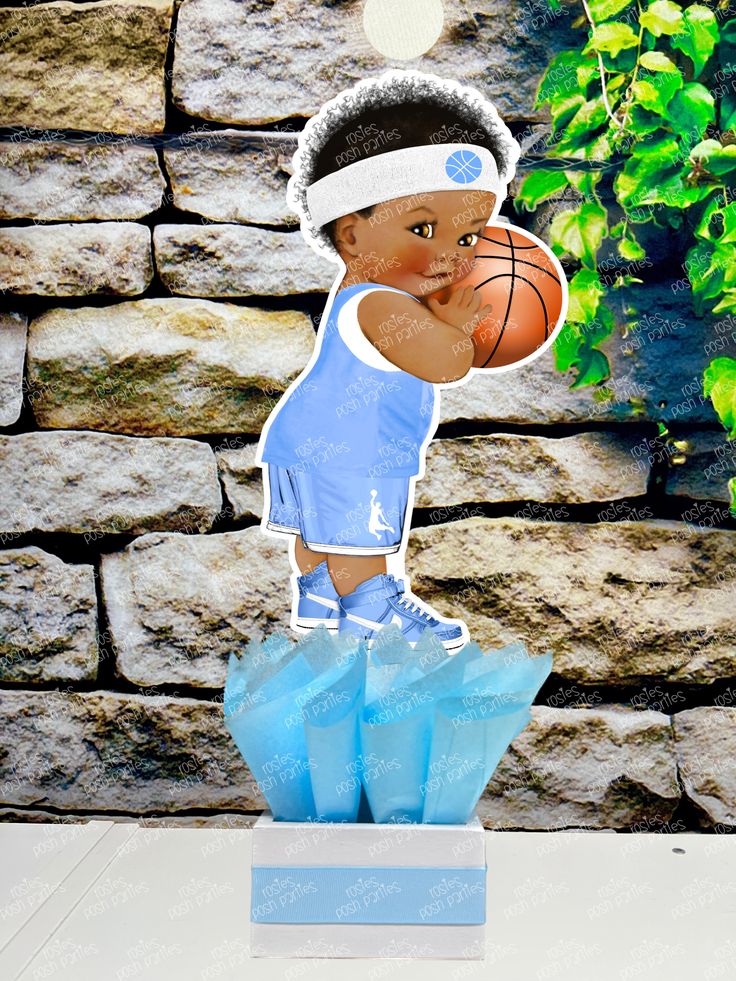 a paper cut out of a basketball player with a headband and blue shorts on