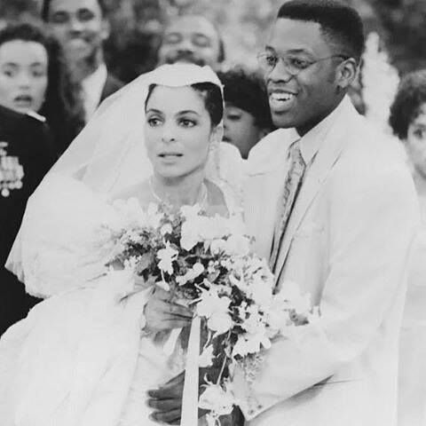 an old photo of a bride and groom in front of a group of other people