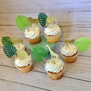 cupcakes with white frosting and gold decorations