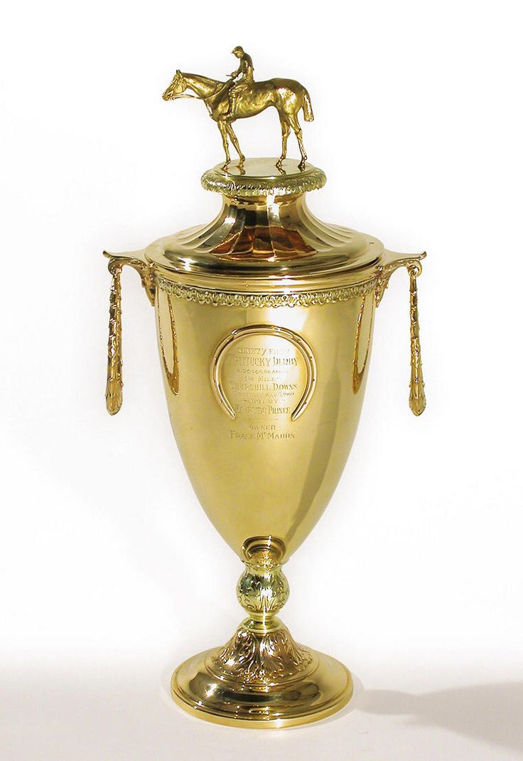 a golden trophy with a horse on top