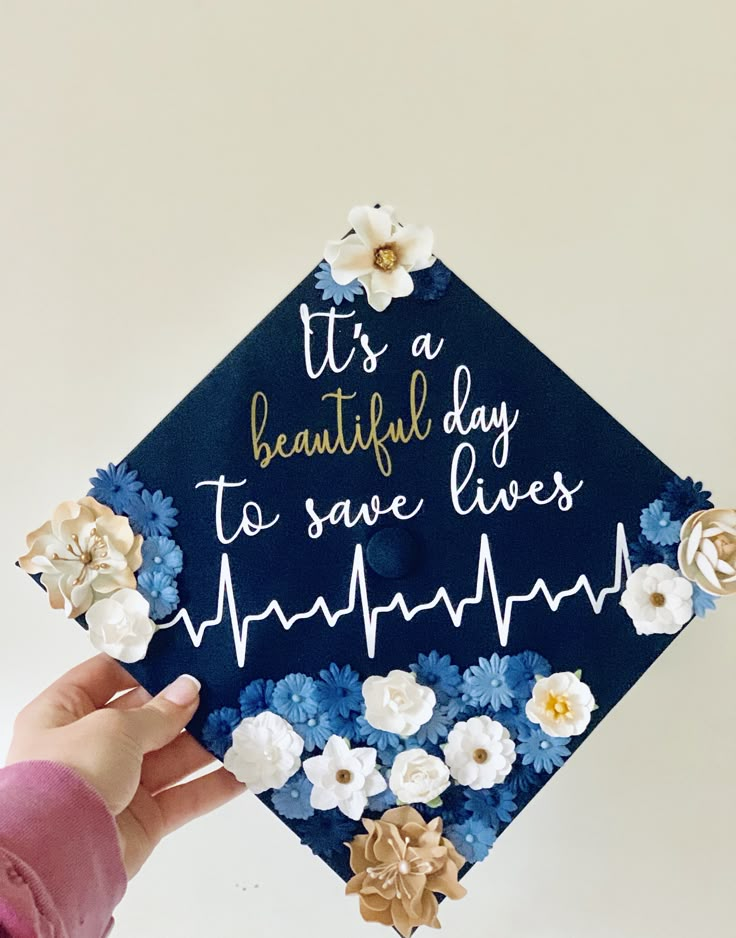 someone holding up a graduation cap that says it's a beautiful day to save lives