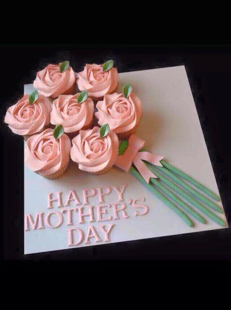 a bouquet of pink roses sitting on top of a white card that says happy mother's day