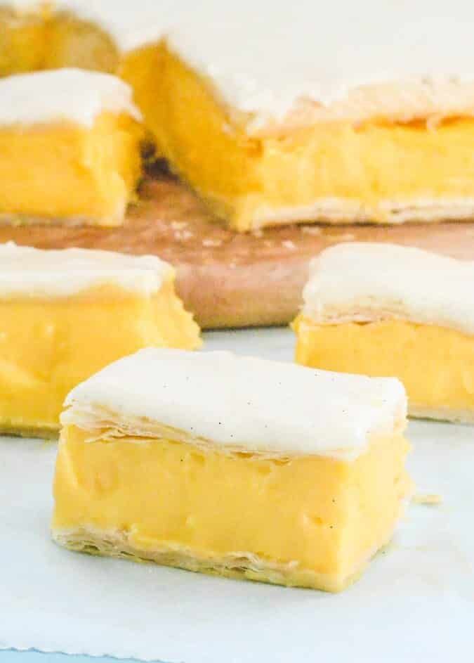 several pieces of yellow dessert sitting on top of a white paper towel next to each other