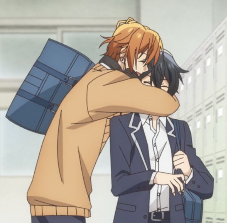 two people hugging each other in front of lockers with boxes on their backs and one person wearing a suit jacket