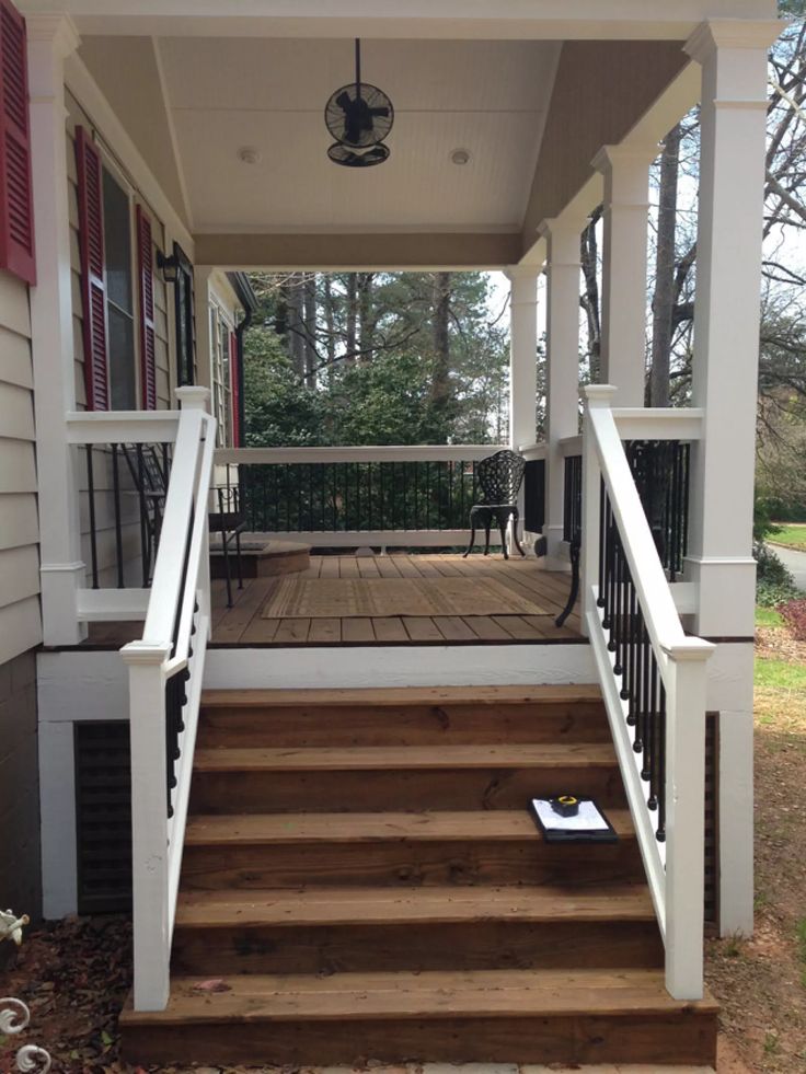 a porch with steps leading up to the front door