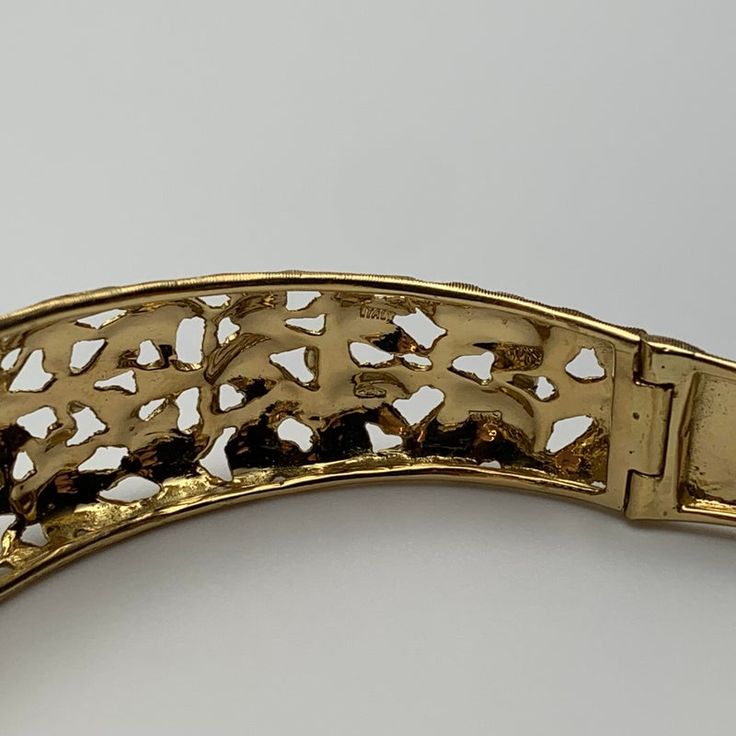 This is part of Chairish’s Fine Jewelry assortment.  This bangle is hand-crafted out of 18 karat yellow gold. It features delicate, florentine engravings of leaves and small flowers. The clasp contains one safety clasp.   Weight: 17.75g Size: 6.5" Luxury Yellow Gold Hinged Bracelet, Ornate Gold Bangle For Anniversary, Ornate Gold Bangle Bracelet For Formal Occasions, Luxury Hinged Yellow Gold Bracelet, Elegant Engraved Metal Bangle, Ornate Yellow Gold Cuff Bracelet For Formal Occasions, Ornate Gold Cuff Bracelet For Anniversary, Luxury Gold Metal Bracelet For Wedding, Evening Hinged Bangle Jewelry