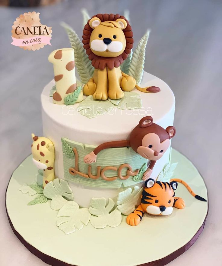 a birthday cake decorated with animals and letters