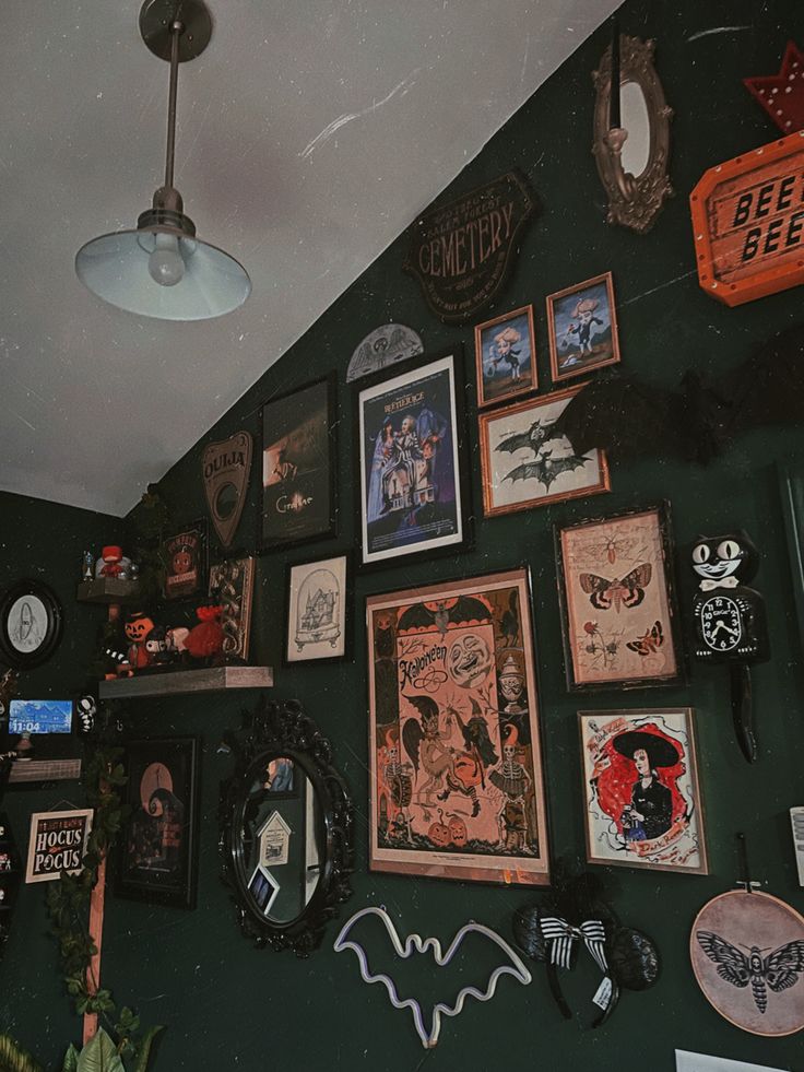 there are many framed pictures on the wall in this room with bats and other decorations