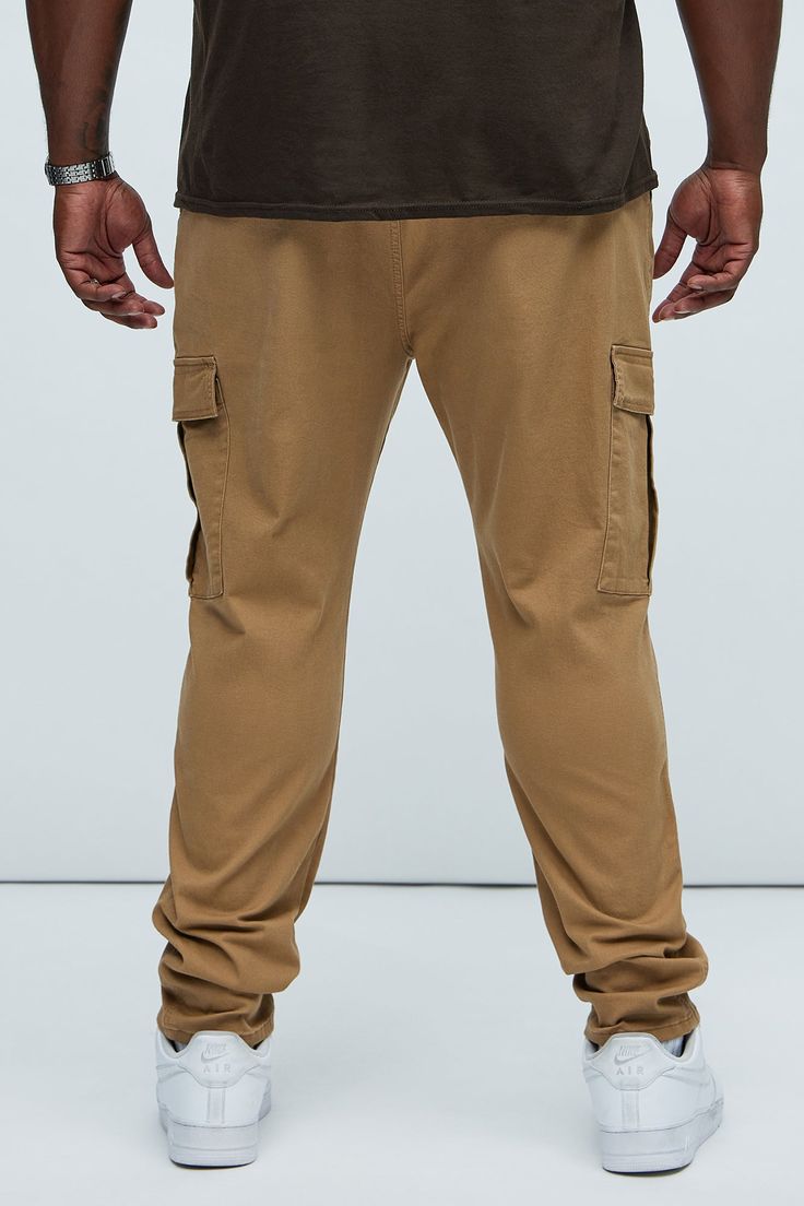 The Kyle Cargo Pants in khaki are the perfect addition to your wardrobe. These sporty men's chinos feature a cuffed ankle length, high waisted rise, and straight leg shape. The brown hue and cotton texture, along with the drawstring detail, add a touch of comfort and style to your look. These ankle-length joggers are a must-have for any fashion-forward individual. | Mens Kyle Slim Cargo Pants in Khaki size 30 by Fashion Nova Casual Brown Cargo Pants For Streetwear, Brown Chinos With Pockets For Fall, Fall Brown Chinos With Pockets, Casual Brown Straight Leg Cargo Pants, Urban Brown Straight Leg Pants, Casual Brown Cotton Cargo Jeans, Khaki Cargo Pocket Sweatpants, Brown Tapered Leg Chinos With Pockets, Casual Brown Straight Leg Chinos