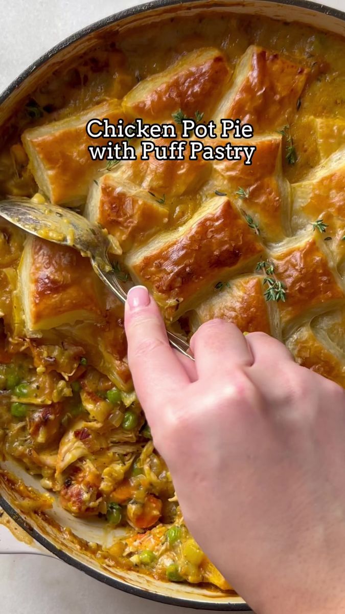 a person is spooning some food out of a casserole