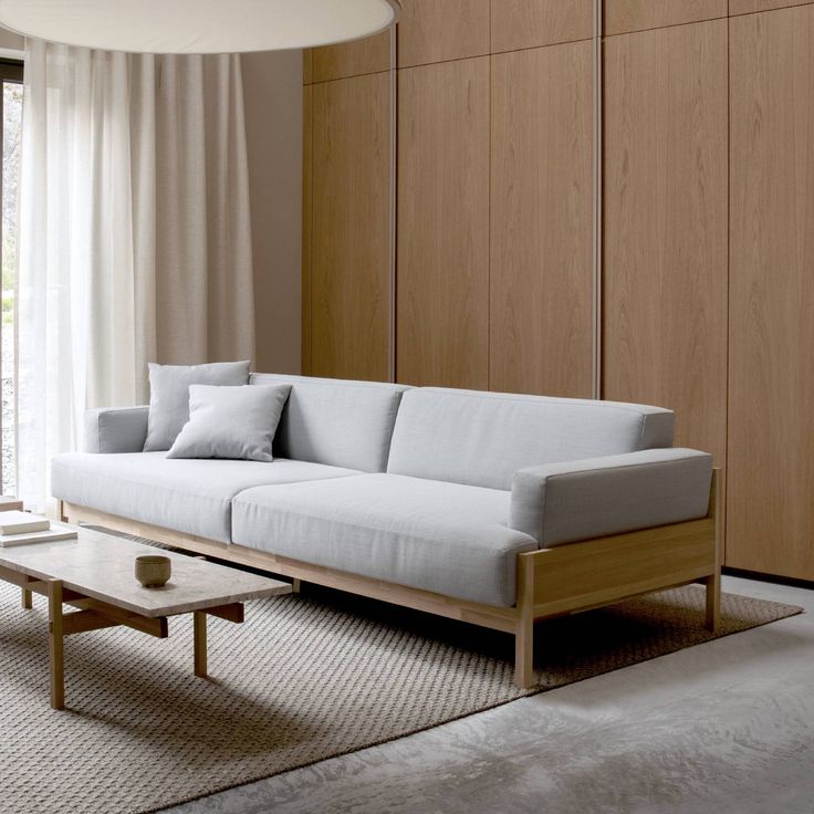 a living room with a couch and coffee table in front of a sliding glass door