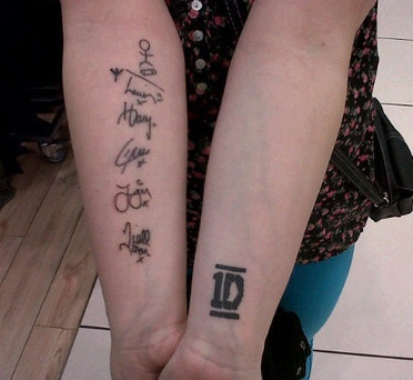 two people with matching tattoos on their arms