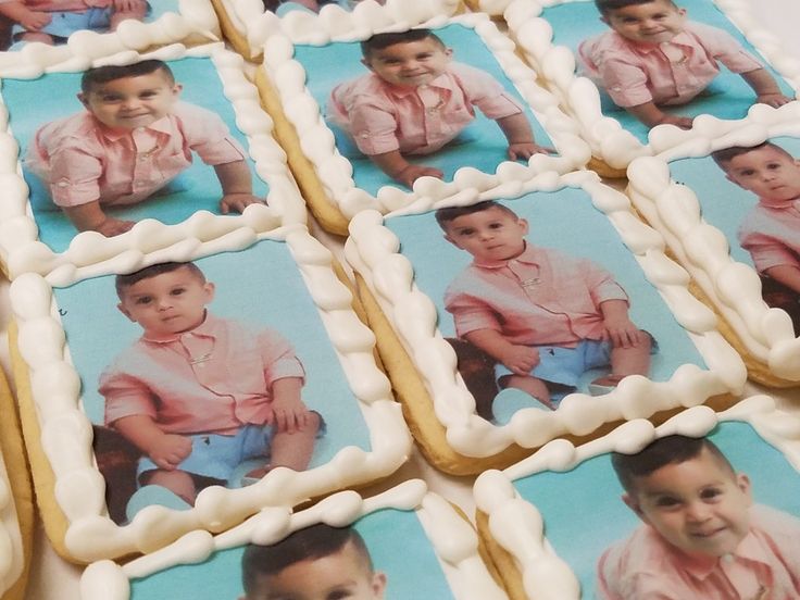 several cookies with pictures of babies on them are arranged in rows and placed next to each other