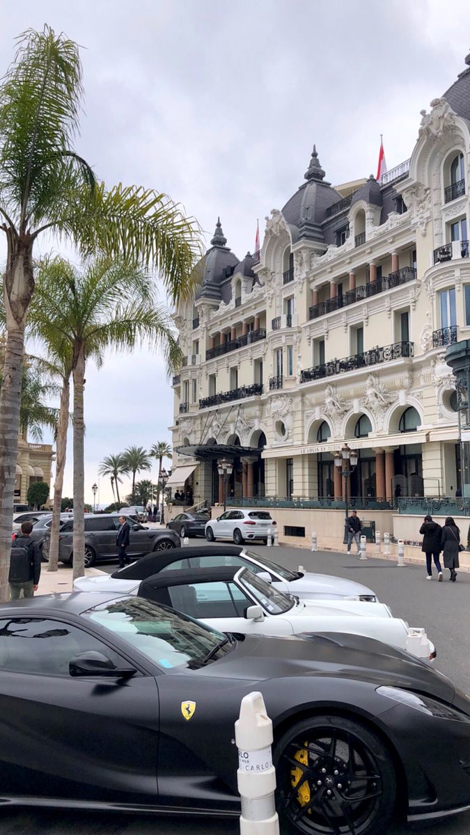 a black sports car parked in front of a hotel