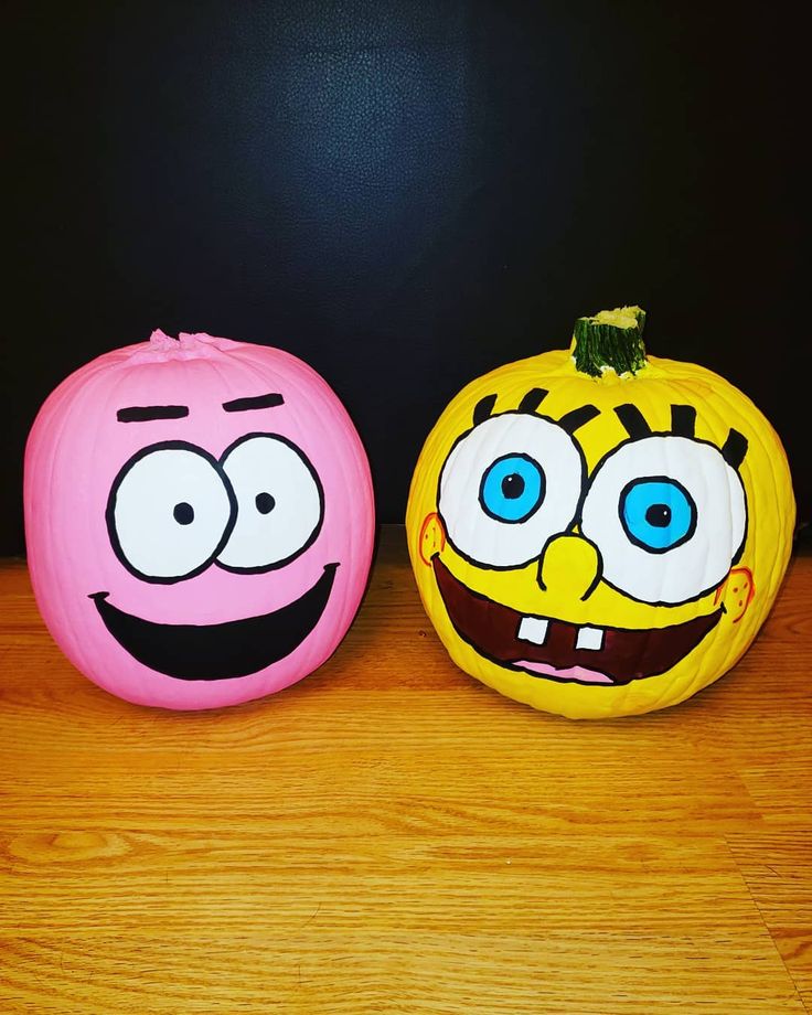 two pumpkins decorated to look like cartoon characters