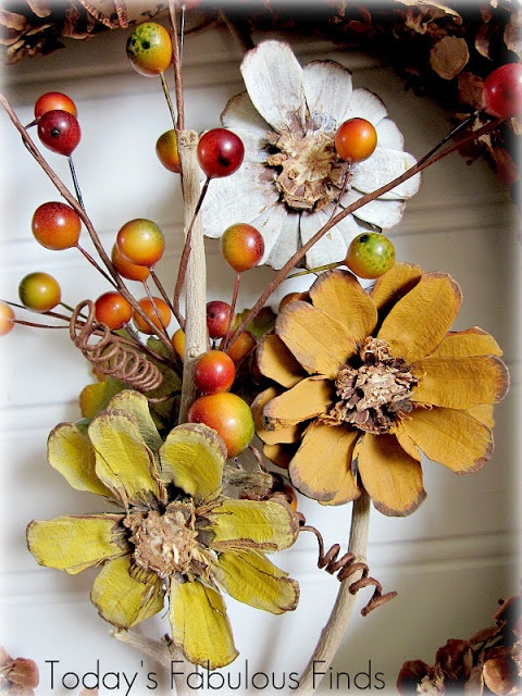 an arrangement of flowers and leaves on a door