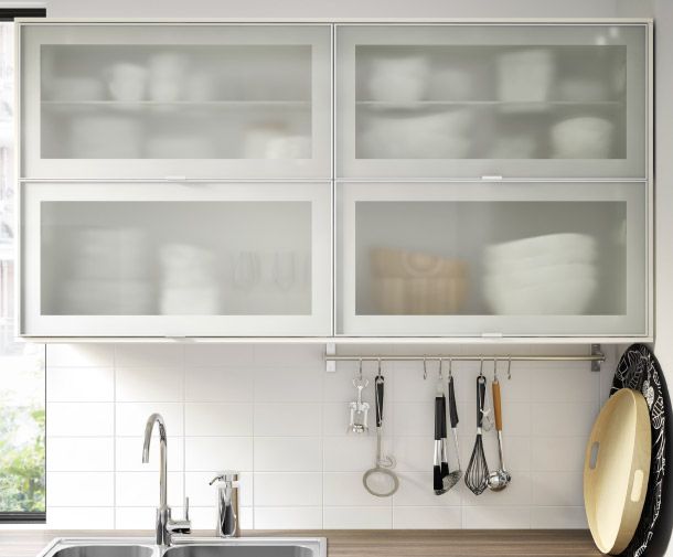 a kitchen with white cabinets and stainless steel sink