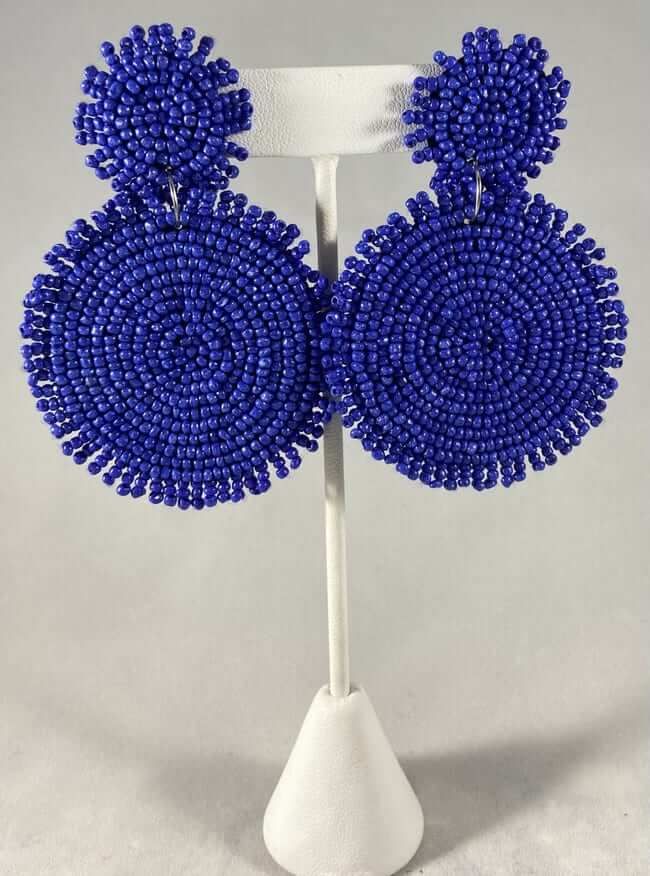 Looking for a unique and funky pair of earrings to wear any time of the day? Look no further than these seed bead circle earrings! Made with bright and colorful beads, these earrings are sure to add a pop of personality to any outfit. At 3.5" in length, they're also the perfect size for any occasion. Blue Beaded Circle Jewelry, Trendy Blue Round Bead Earrings, Trendy Blue Beaded Earrings For Summer, Trendy Blue Earrings With Dangling Beads, Blue Round Beaded Earrings With Colorful Beads, Trendy Circular Earrings With Colorful Beads, Trendy Round Beaded Earrings, Trendy Blue Beaded Earrings, Colorful Beaded Circle Earrings For Summer