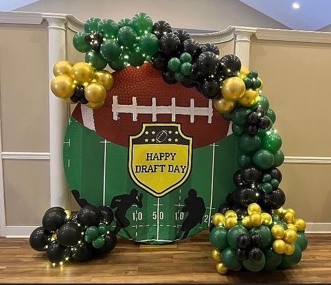 a football themed balloon arch with balloons