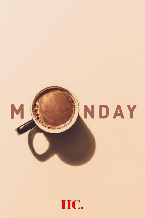 a cup of coffee sitting on top of a white table next to the words monday