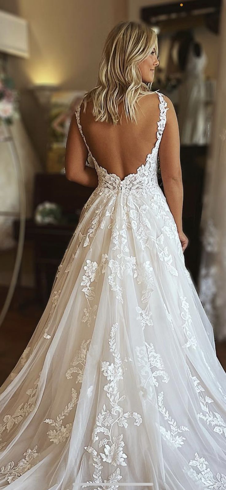 a woman in a wedding dress looking back