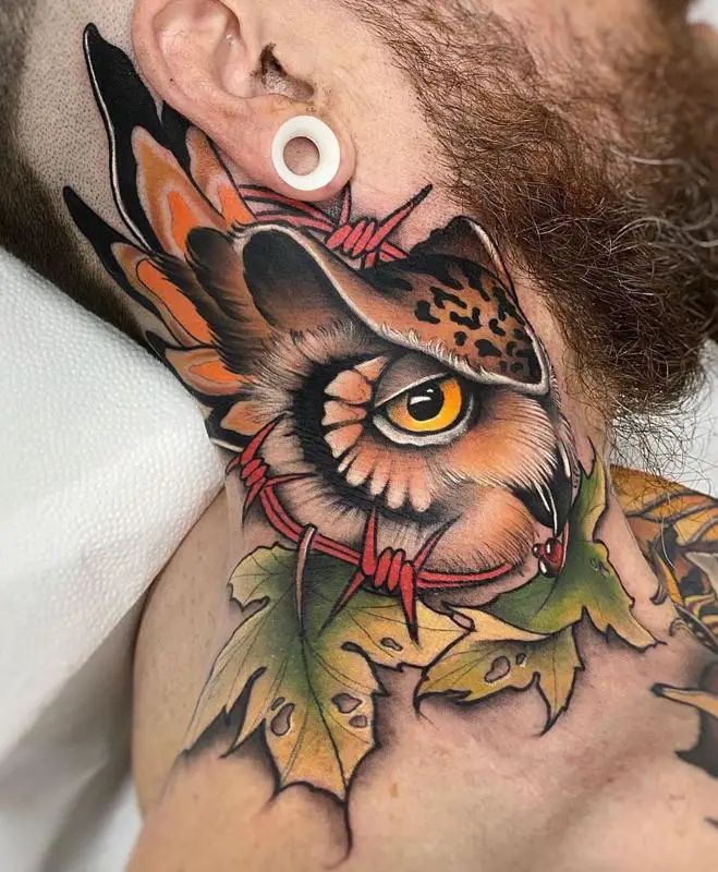 a man with a tattoo on his neck has an owl and leaves behind the ear