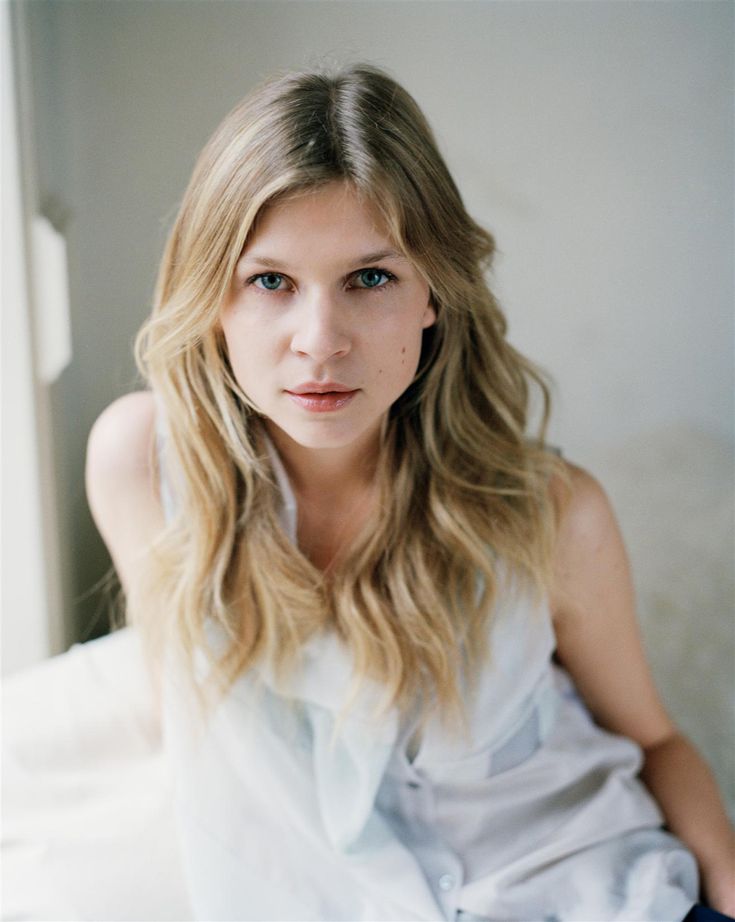 a woman with long blonde hair wearing a white dress and looking at the camera, with text that reads meet clemence poesy