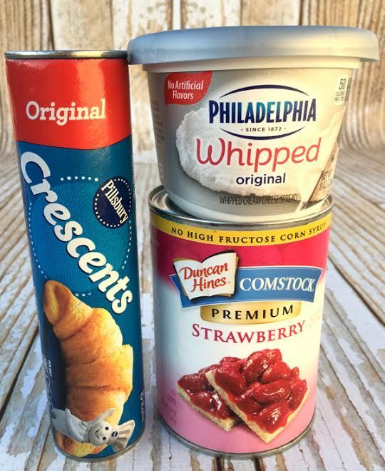 two cans of ice cream sitting next to each other on a wooden table with white boards