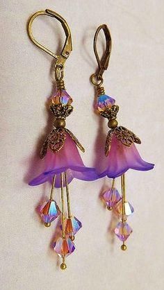 purple flower earrings with swarong crystals hanging from them