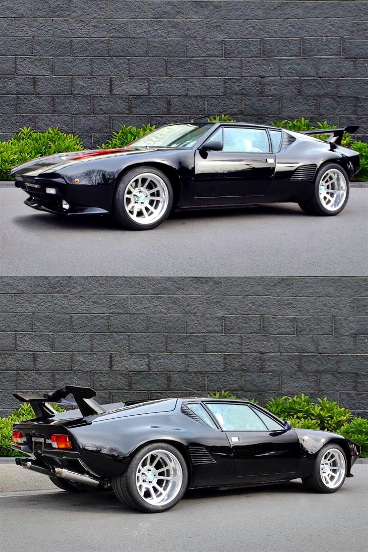 two different views of a black sports car parked in front of a brick wall and grass