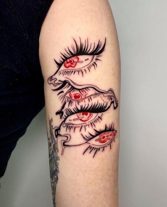 a woman's arm with tattoos on it and an eyeball in the middle