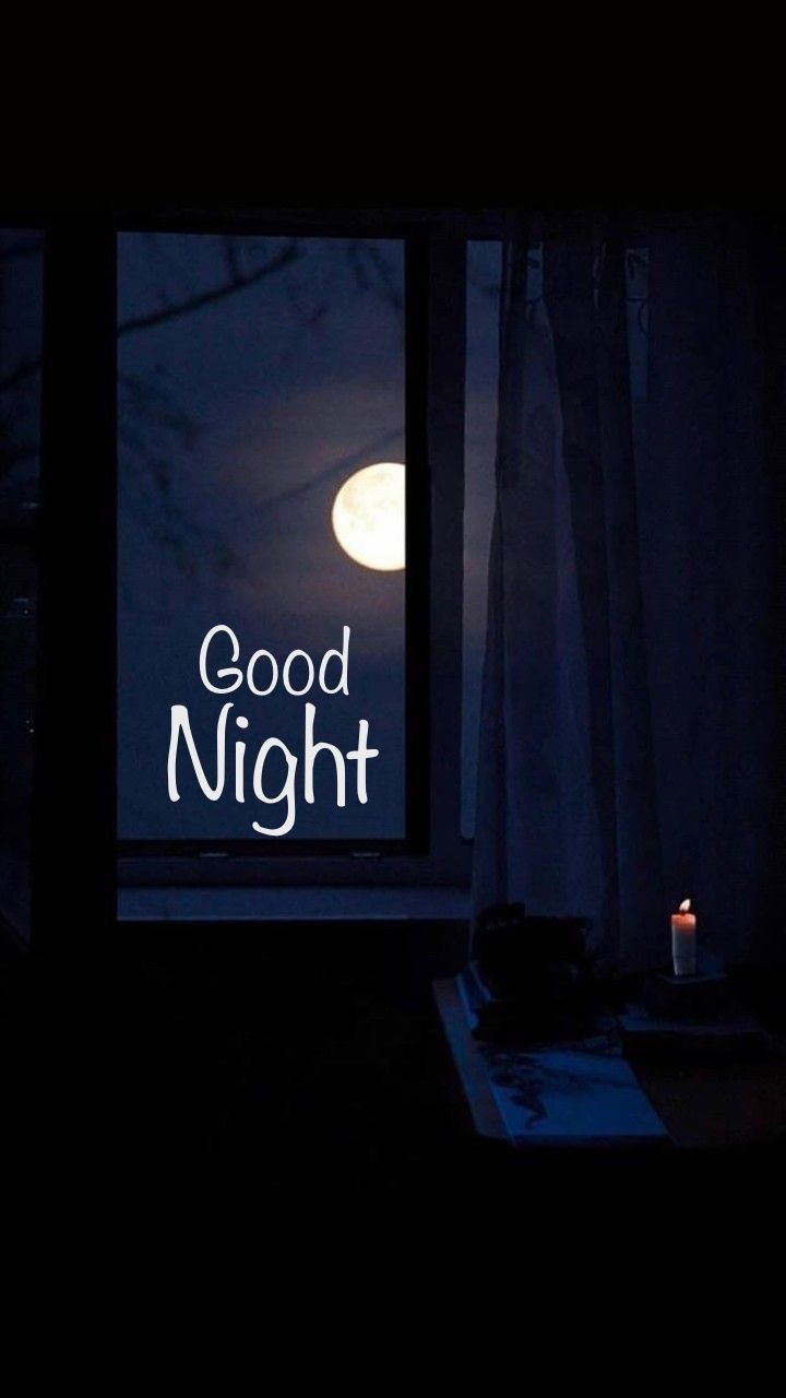 a window with the words good night written on it and a lit candle next to it