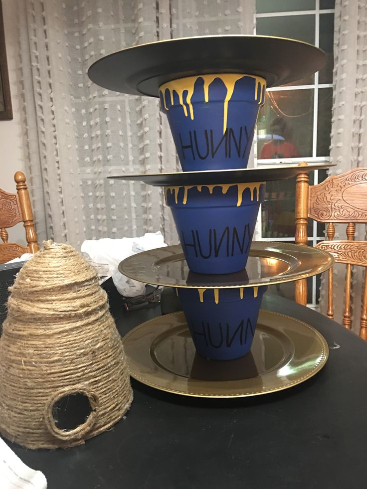 three tiered blue and yellow vases sitting on top of each other