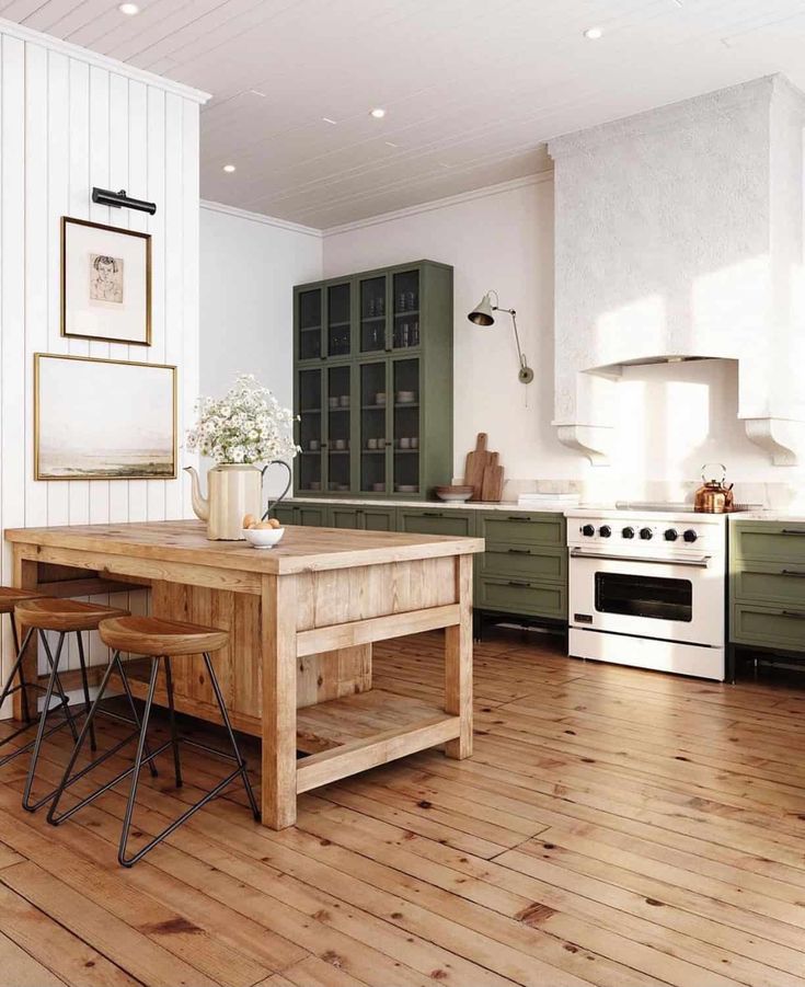 a kitchen with wooden flooring and green cabinetry next to a stove top oven