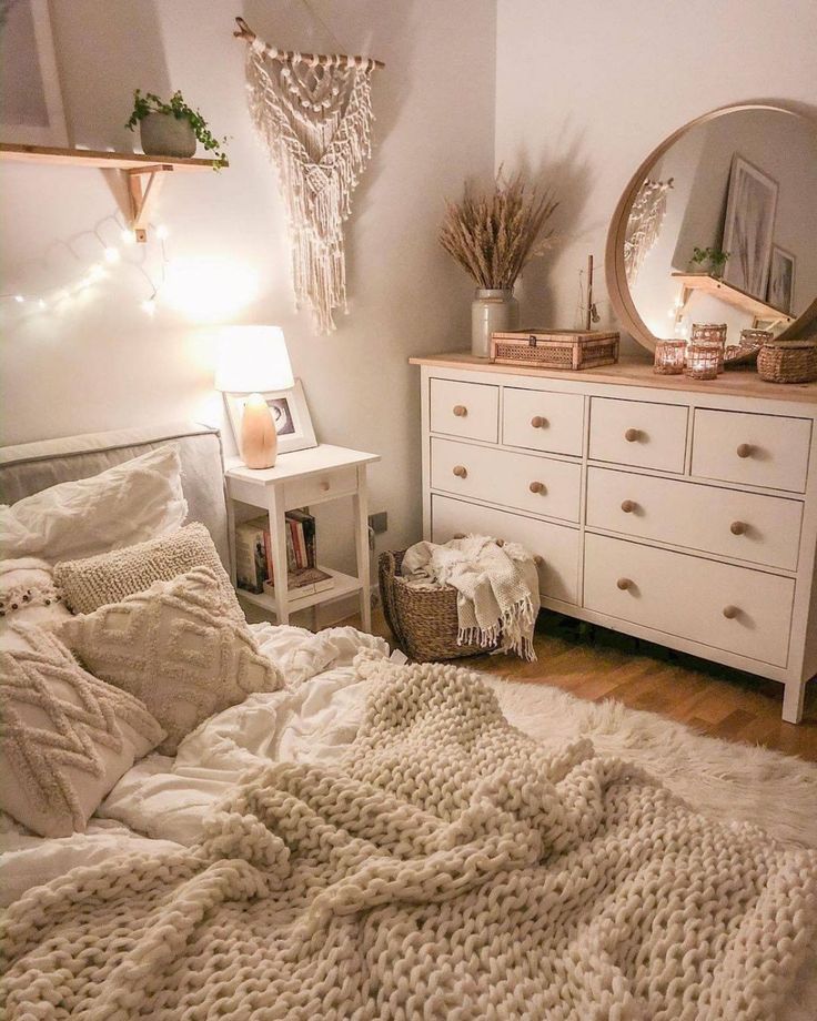 a bedroom with a bed, dresser and mirror on the wall next to each other