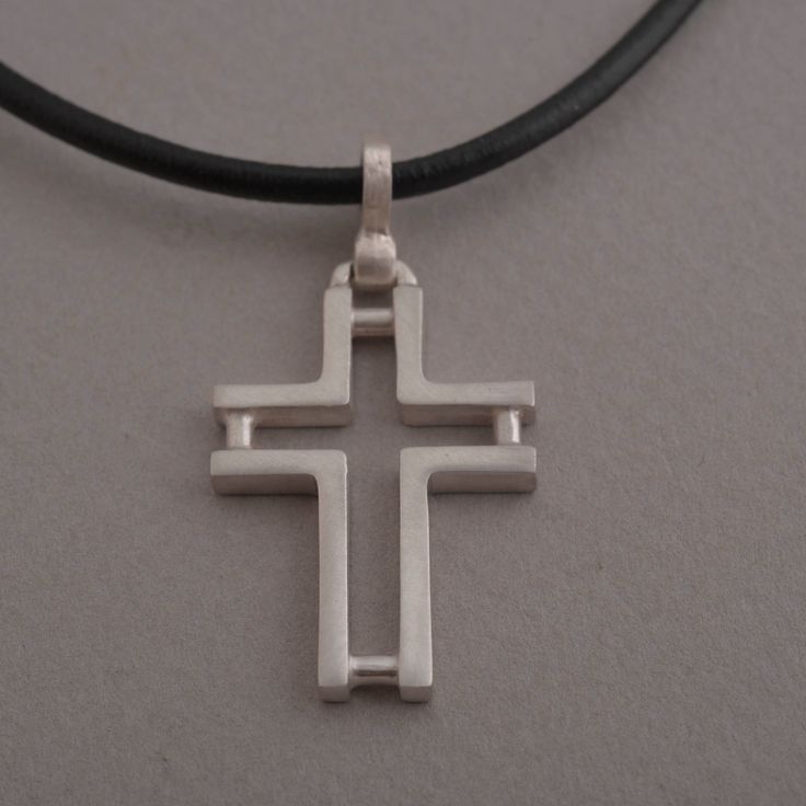 Minimal line and ingenious design characterize this beautiful sterling silver cross pendant necklace for men or women. The effect is minimalistic, yet alluring. Suspended from a silver chain or leather cord with silver clasp and endings, it is a stylish accessory for anyone that wants to keep their faith close to their heart and share it for the world to see. This also makes a stunning Christian gift for a special person in your life. Cross measures 3.8 cm x 2 cm. You get the cross with a 48 cm Minimalist Sterling Silver Cross Pendant Necklace, Modern Sterling Silver Cross Pendant Jewelry, Modern Sterling Silver Cross Pendant, Minimalist Silver Cross Necklace, Minimalist Sterling Silver Pendant Cross Necklace, Modern Silver Necklace With Cross Pendant, Minimalist White Gold Cross Necklace, Modern Crucifix Cross Necklace As Gift, Minimalist Adjustable Cross Pendant Necklace