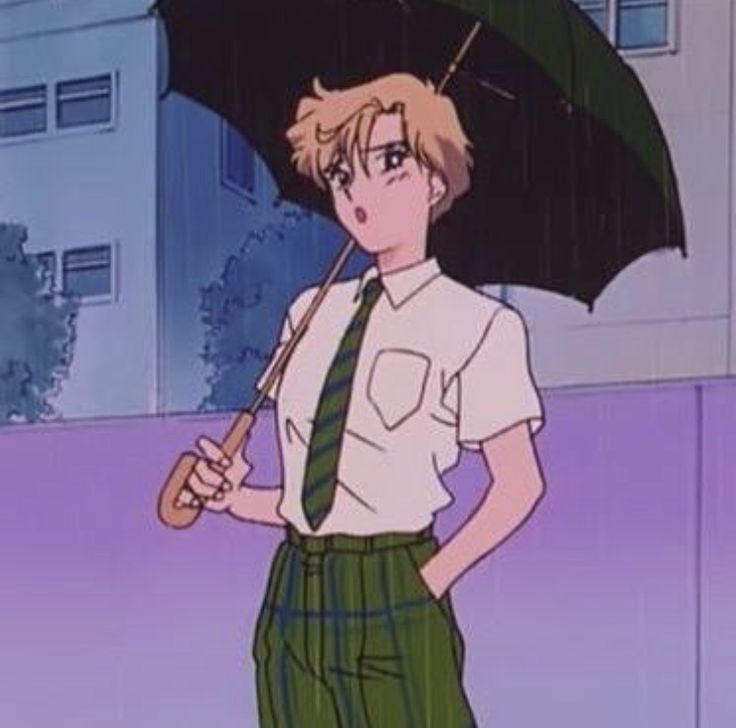 a young man holding an umbrella while standing in front of a building on a rainy day