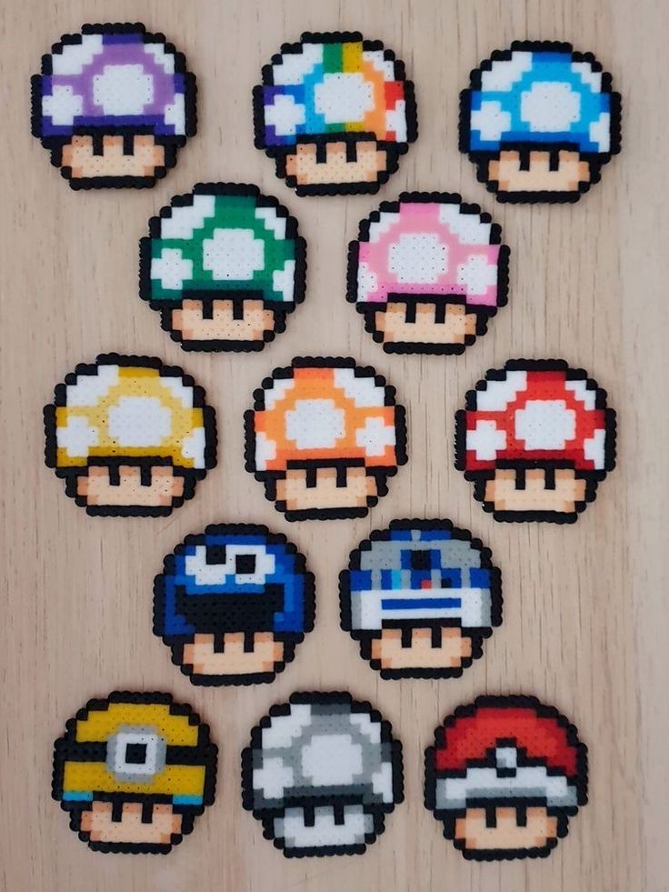 the pixelated mario bros characters are arranged on a wooden surface, each with different colors and sizes