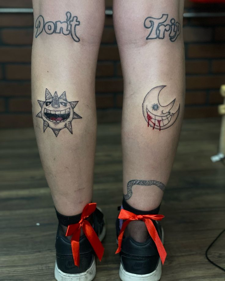 two people with tattoos on their legs