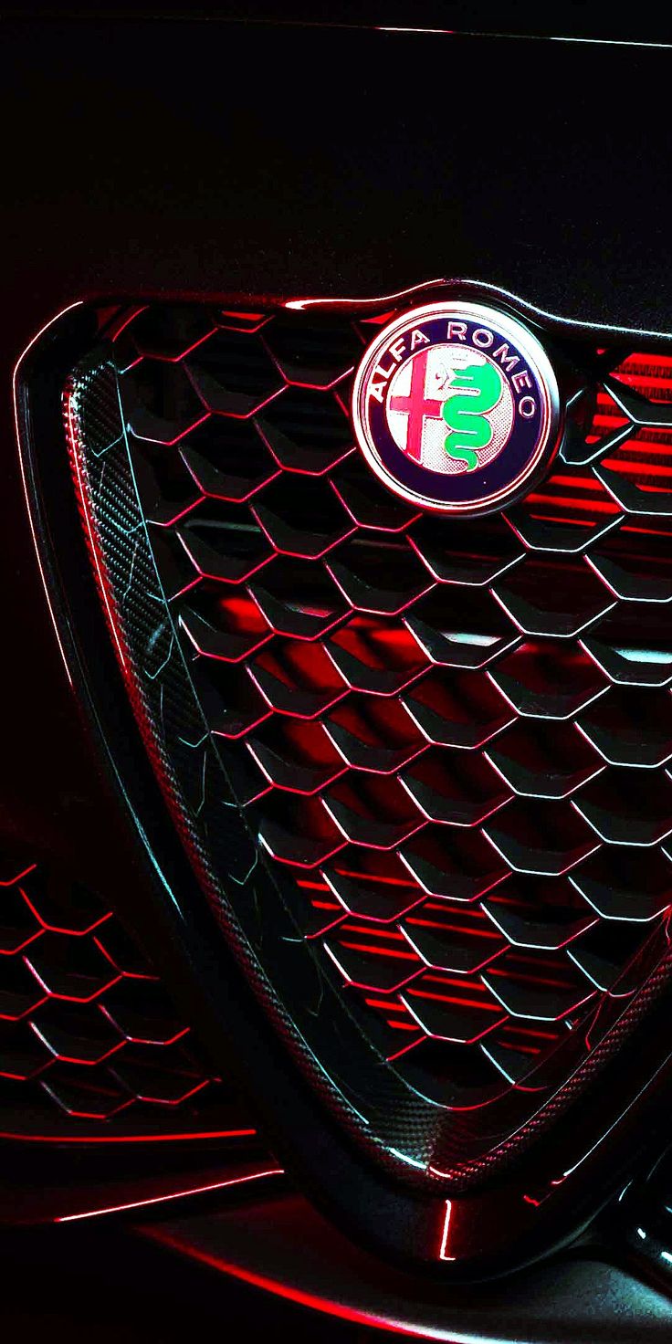 the front grille of a black car with red lights