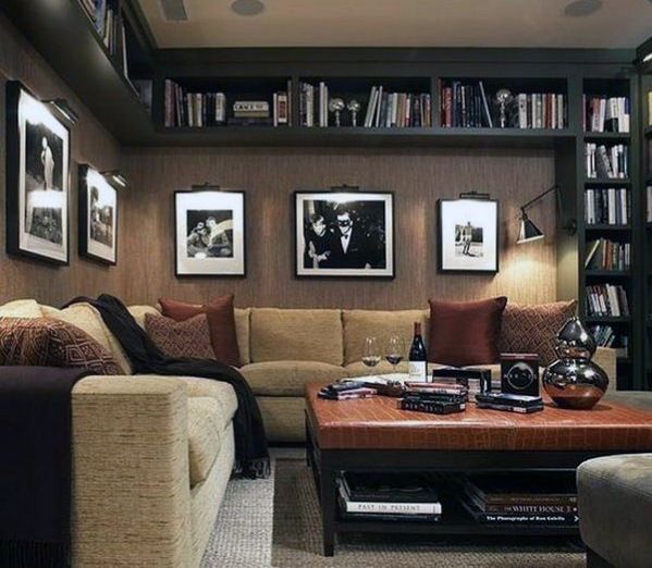 a living room filled with lots of furniture and bookshelves covered in pictures on the wall