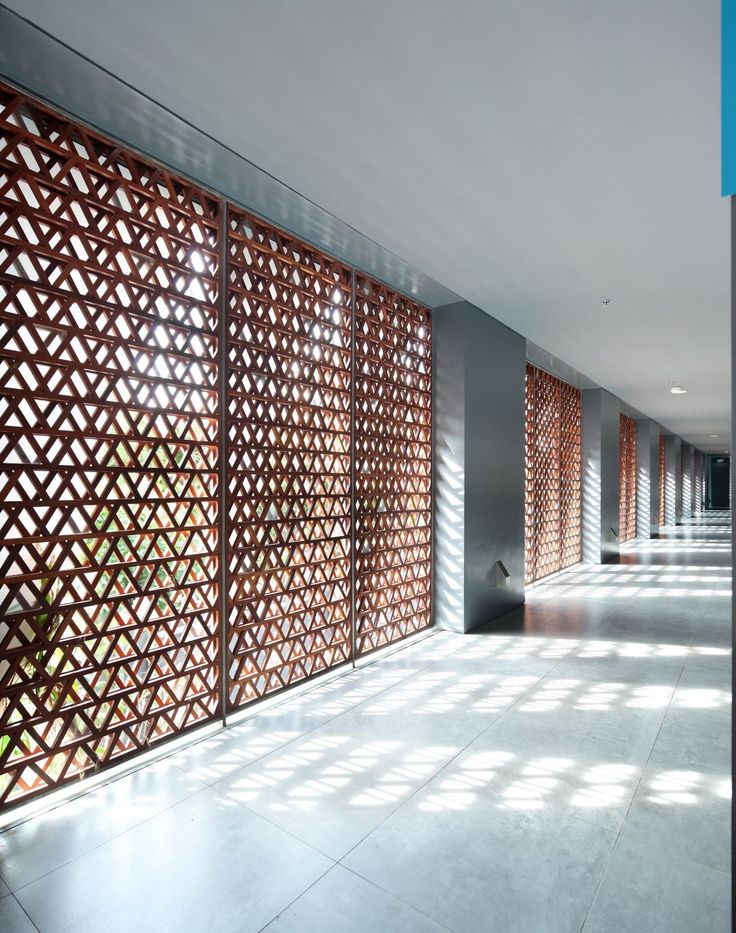 an empty hallway with wooden slats on the wall and flooring in front of it