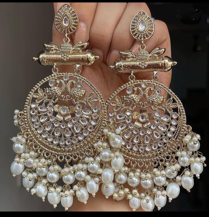 a pair of earrings is being held up