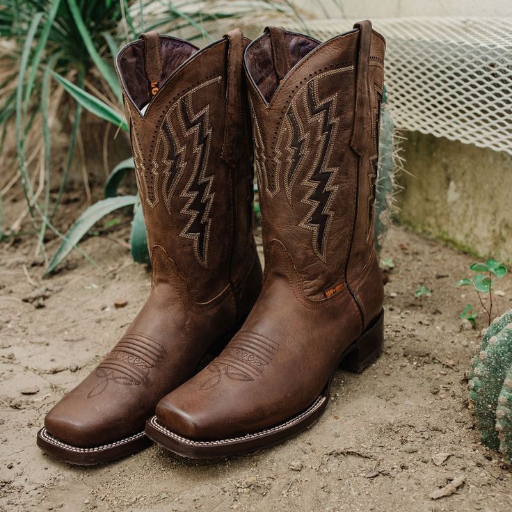 Enjoy that country feel in these classically rugged, casual western boots for men. As an everyday boot, it sports brown distressed leather underneath traditional Western stitching on the front. Inlays on the shaft add and a narrow square toe adds that final country touch, while genuine leather throughout, a cushioned insole and leather lining ensure you're comfortable wearing these country boots all day. And don't worry about wearing them out; Goodyear welt construction means they're built to la Mens Square Toe Boots, Country Wedding Boots, Kids Boots Boys, Cowboy Boots Brown, Square Toe Cowboy Boots, Brown Cowboy Boots, Western Boots For Men, Everyday Boots, Wedding Boots