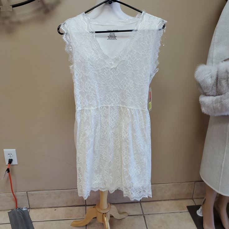 Beautiful Brand New Dress With Gorgeous White Lace Throughout. It Is A Mini Length And Still Has Tags Attached Casual Knee-length Lace Dress, Casual Lace Dress For Day Out, V-neck Lace Dress For Daywear, Casual Fitted Lace Trim Dress, Casual Fitted Lace Dress With Lace Trim, Casual Fitted Lace Dress, Fitted Casual Lace Dress For Day Out, Casual Fitted Lace Dress For Day Out, Casual Lace Dress For Daywear