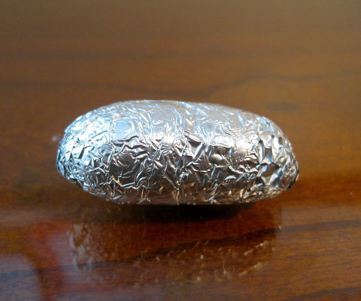 a piece of tin foil sitting on top of a wooden table