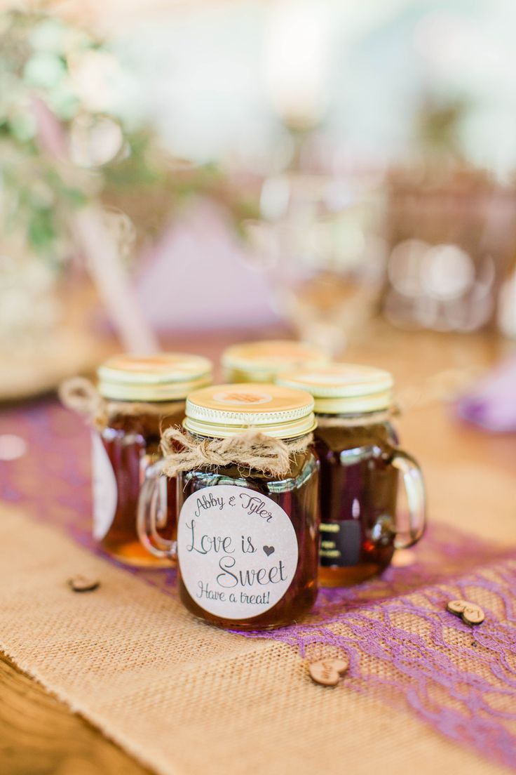 jars filled with honey sitting on top of a table