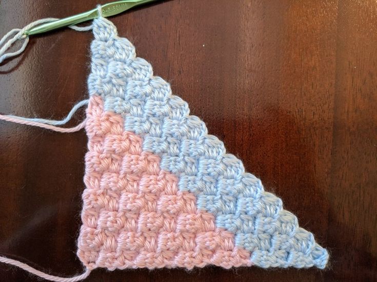 a crocheted triangle is sitting on a table