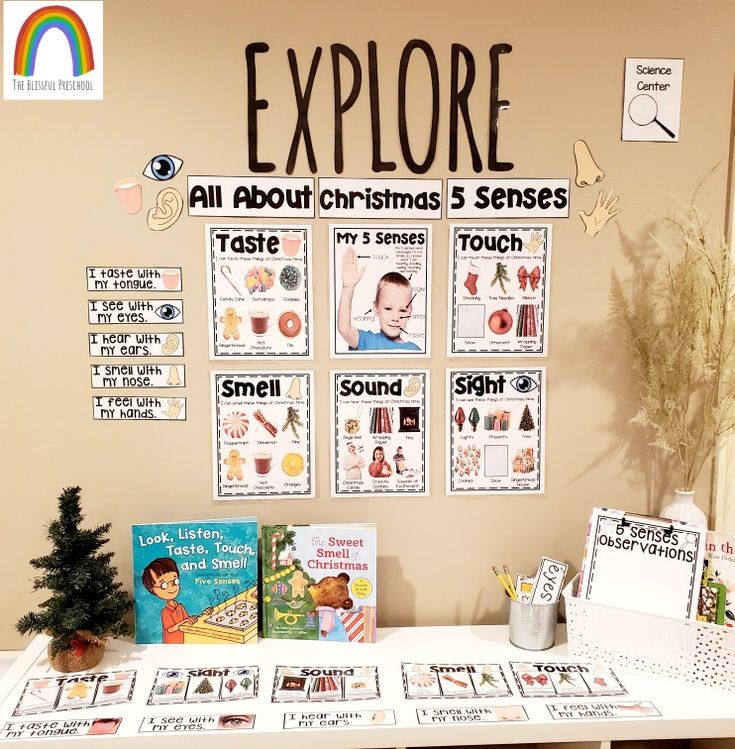 there is a table with books and pictures on it in front of a sign that says explore all about christmas